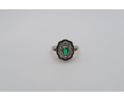 A 14ct hallmarked emerald and diamond cluster ring with diamond accent shoulders, size L, approx 2.8 grams, some missing ston