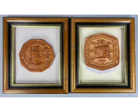 TWO CERAMIC TOKEN PLAQUES, 'Castell Caernarfon' and 'Castell Biwmares', each mounted and contained in a frame, 39 x 34cms ove