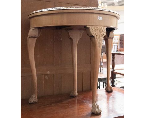 A Crossbanded and Carved Demi Lune Foldover Card Table, on hairy paw feet, 84cm by 42cm by 77cm