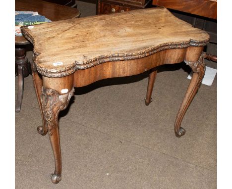 An 18th Century Carved Mahogany Fold Over Card Table, with shaped top on carved legs and scroll feet, 91cm by 45cm by 75cmSin