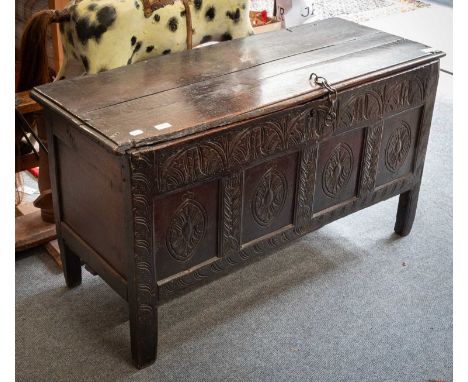 An 18th Century Carved Oak Coffer, with four panels and lunette carving, 124cm by 46cm by 66cm