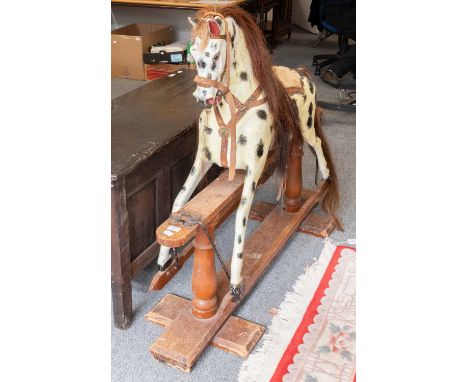 A Painted Rocking Horse on Pine Trestle Base, late 19th/early 20th century, 112cm to tips of ears, tressel 135cm longHas been