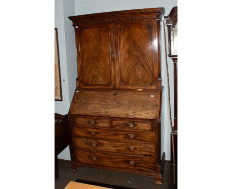 A George III Mahogany Bureau Bookcase, with dentilled and blind fretwork carved cornice, the doors and drawers flanked by flu