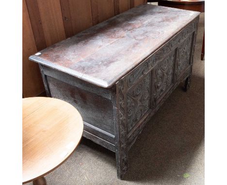 A 17th Century Oak Three Panel Coffer, profuseley carved with scrolls and flower heads, 130cm by 55cm by 75cmStructurally sou