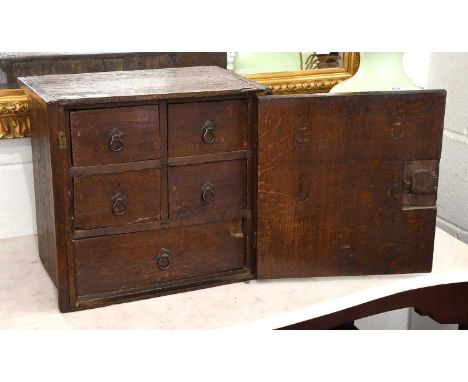 A Small 18th Century Oak Cupboard, the hinged door opening to reveal an arrangement of drawers, 41cm by 27cm by 38cmThe top w