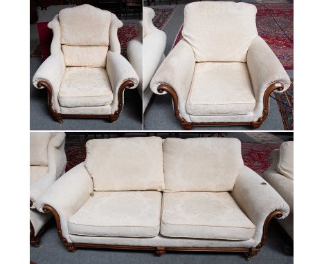 A WADE Three Piece Suite, cream upholstery with carved walnut frame, comprising a sofa and two chairs