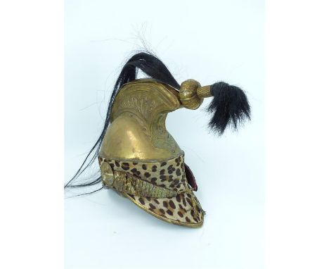 An early 19th century French Cuirassier Calvary helmet, with later adaptations, with leopard skin mount.