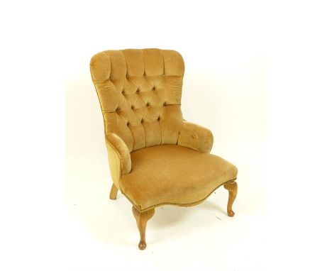 A Victorian spoon back armchair upholstered in mustard velour with button back, raised on cabriole supports, 85 x 62 x 75cm.