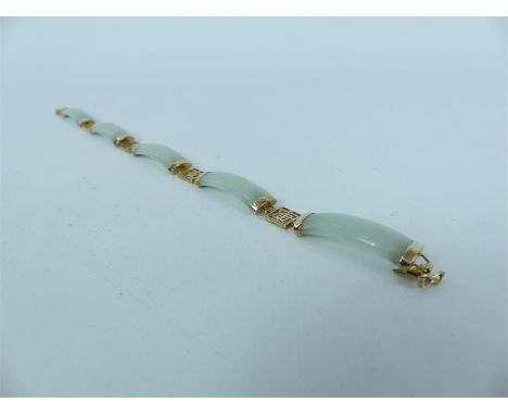 A 9 carat gold jade bracelet with Chinese symbol spaces; length 19 cm.