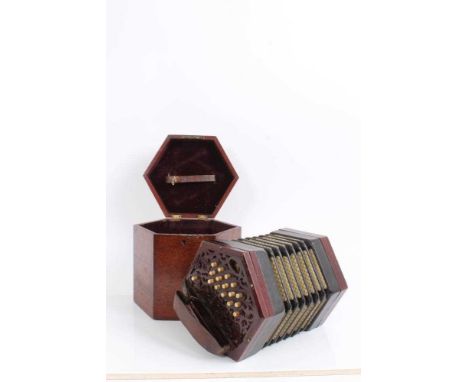 A good quality 30 key rosewood concertina with fretwork ends and bone keys, probably Lachenal, in original case