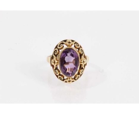 14ct gold amethyst cocktail ring with an oval mixed cut amethyst in an open work scroll setting, size N½Shank stamped 585 and