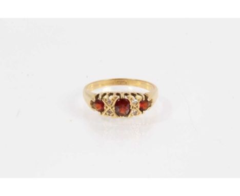 18ct gold garnet and diamond ring with three mixed cut garnets interspaced with brilliant cut diamonds, size PShank stamped 1