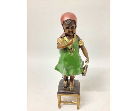 A painted bronze figure of a girl standing on a stool, 14½" high