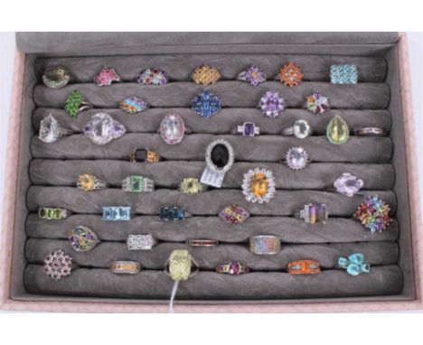 Collection of 43 silver gem set dress rings displayed in a ring tray