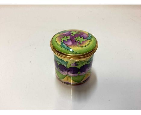 Moorcroft enamel trinket box decorated with purple flowers on green ground, in original boxPerfect