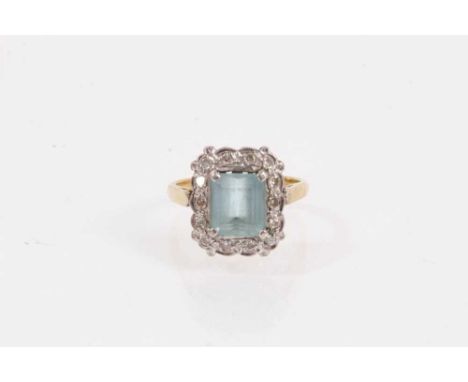 18ct gold aquamarine ring with diamond border in platinum setting on 18ct yellow gold shank, size M½Shank stamped 18ct and we