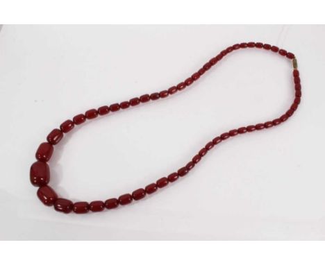 Simulated cherry amber necklace with graduating polished oblong beads, 75cm long Weight 57 grams.Please see images of the bea