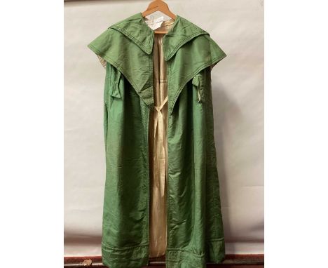 1835 Georgian green silk cloak with double collar and lined with cream silk, padded hemline.The overall condition is fair to 