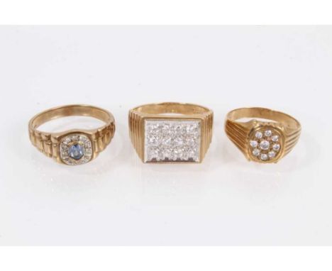 Two 9ct gold rings set with synthetic white stones and one other 9ct gold blue stone ring, all with textured shoulders on 9ct