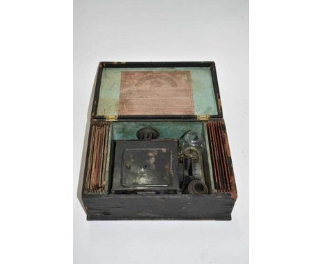 Antique German magic lantern in case with slides - original trade label to inside of case
