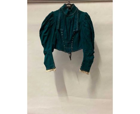 c1890's cropped wool boned jacket with full leg of mutton sleeves and militarty influenced braid trim, center seam at the bac
