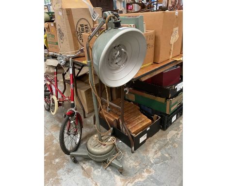 Old hospital lamp with adjustable height, on tripod base