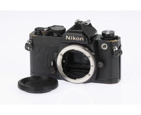 A Black Nikon FM 35mm SLR Body 1977-82, serial no.2514721, shutter and self timer working, body P-F, heavy wear and brassing 