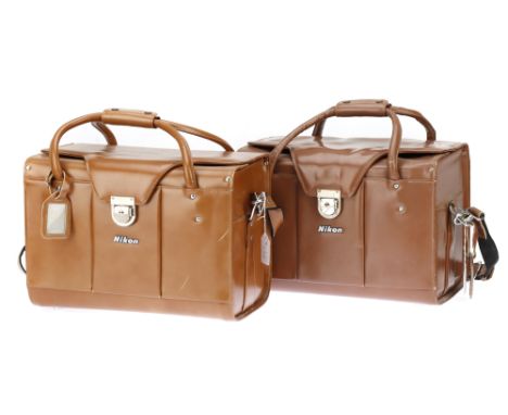 A Pair of Nikon FB-11 Brown Cowhide Camera Outfit Cases with some internal fittings and straps, one case has a shelf for two 