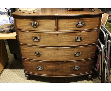 A 19th century mahogany bow front chest of drawers on turned feet.