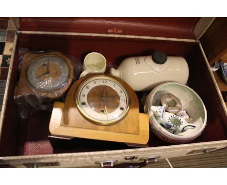 A retro suitcase containing two mantle clocks and mixed china various to include Clarice Cliff.