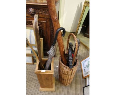 Two stick stands containing sticks and various other oddities.