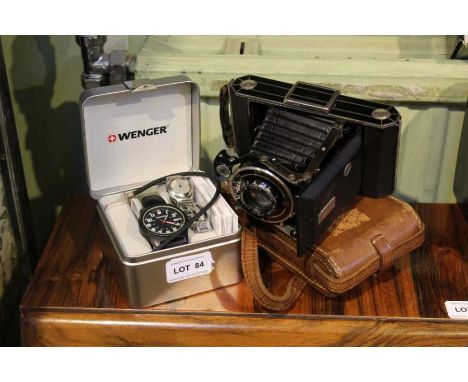A boxed Wenger Swiss made gentleman's wristwatch together with a Swatch watch on a silvered bracelet strap and vintage camera