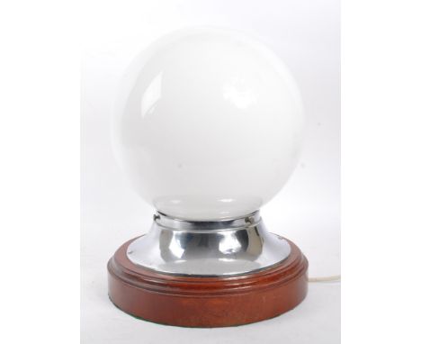 Large vintage 20th century table lamp on circular wooden plinth base with globe opaque shade and chrome fitting. Measures 34c
