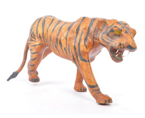 A 20th Century circa. 1960s painted faux leather papier mache French tiger figure. The figure being modelled in the form of a