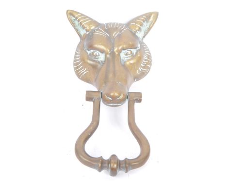 A large brass 20th Century vintage brass door knocker in the form of a fox head with swing handle. Measuring approximately 24