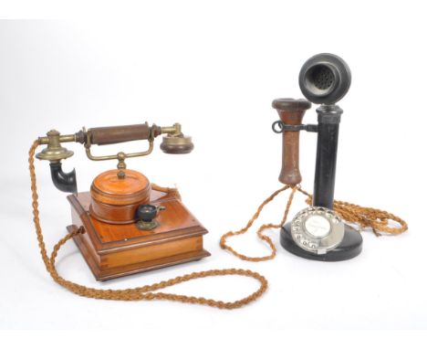 An early 20th century candlestick upright telephone. With metal ring dial with receiver on a holder on a circular base. Toget