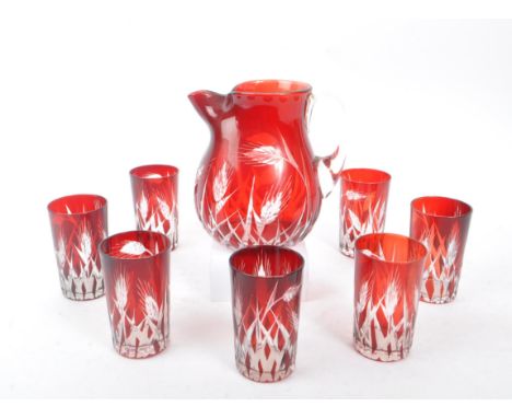 A mid Century vintage Bohemian ruby / cranberry red cut glass drinking / lemonade set comprising of jug with seven glasses. C