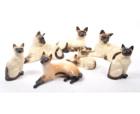 Royal Doulton - A collection of six 20th Century vintage china porcelain Royal Doulton siamese cat figurines in varying posit