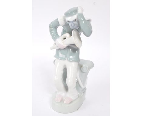 An early 20th Century 1920s art deco French china porcelain figurine in the form of a monkey / chimp wearing marching band cl