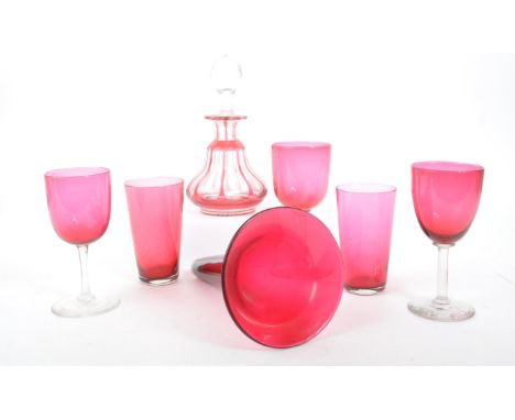 A collection of 19th century and later cranberry drinking glasses with cut glass decanter. Three stemmed and two short / tumb