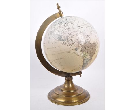 A large vintage 20th century desk top globe. The globe featuring a brass style mounting, raised on a stepped circular base. M