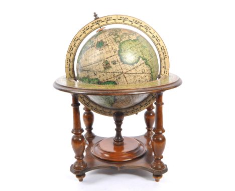 A vintage 20th century desktop terrestrial world globe. The globe supported in a walnut wooden stand, with turned supports. H
