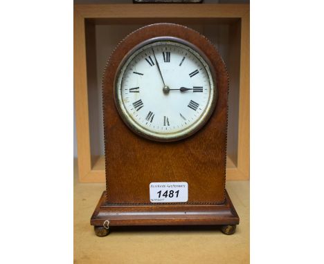 An Edwardian mahogany dome topped mantel clock, string inlaid edging, French movement