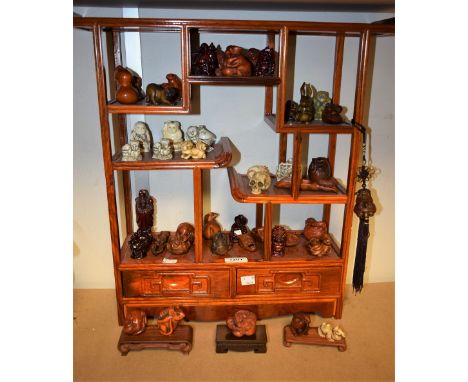 A collection of Japanese hardwood Netsuke, various forms including mythical animals, deity's, scenes of folklore; etc, 20th C