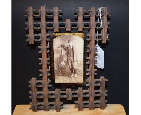 Cycling - a Victorian tramp art easel photograph frame, containing a photograph of a man with a penny farthing or ordinary bi