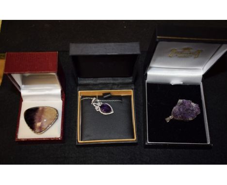 A silver and Blue John Flourite brooch shaped rounded triangular cabochon, collar mounted, stamped TLM sterling; a raw amethy