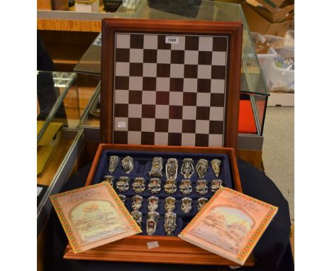 A cast pewter Lord of the Rings chess set by Danbury Mint, cased within board (missing two pieces) with certificate 3107