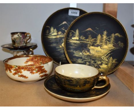 A Japanese Satsuma shaped circular bowl, printed and painted with a mountainous landscape with bridge over a stream, gilded, 