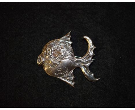An unusual early/ mid 20th century abstract silver brooch, as a fish, incised and impressed scales, mouth and tail, unmarked 