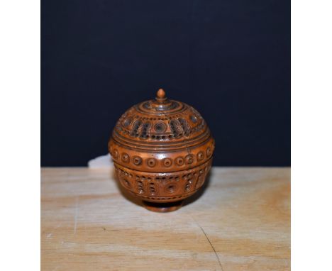 A 19th century coquilla nutmeg  box, pierced and carved throughout with circles, domed screw-cover, turned finial, circular b